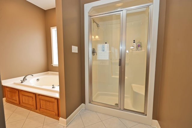 bathroom featuring tile patterned floors and independent shower and bath