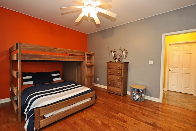 bedroom with ceiling fan and wood-type flooring