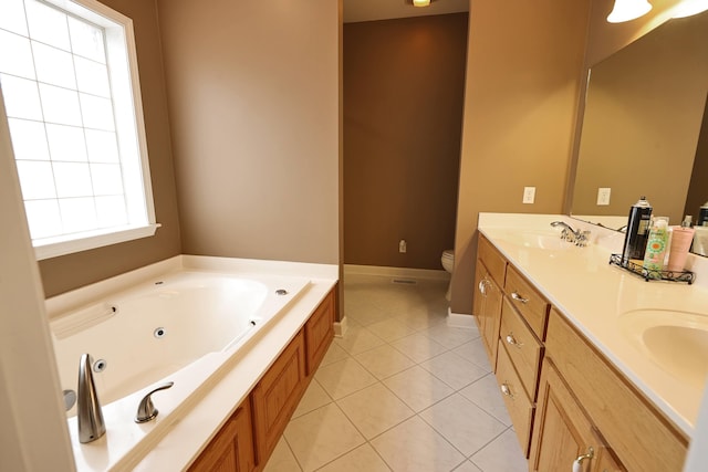 bathroom featuring vanity, toilet, a bath, and tile patterned floors