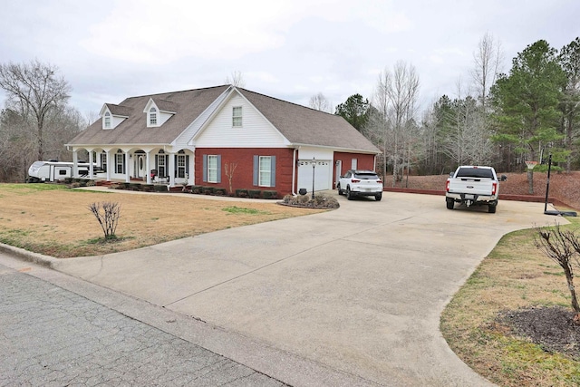 view of front of home with a porch, a garage, and a front yard