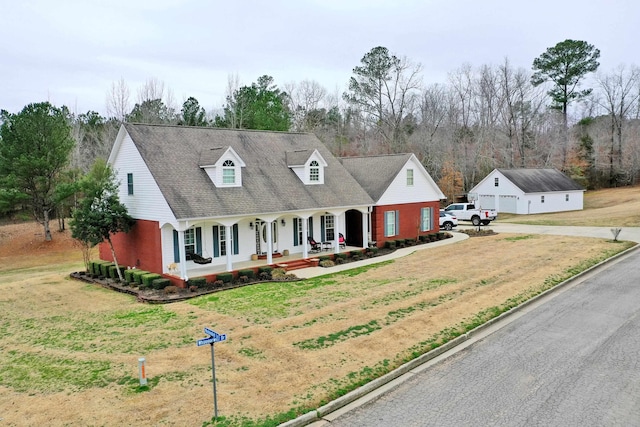 cape cod home with a garage, a front lawn, and a porch