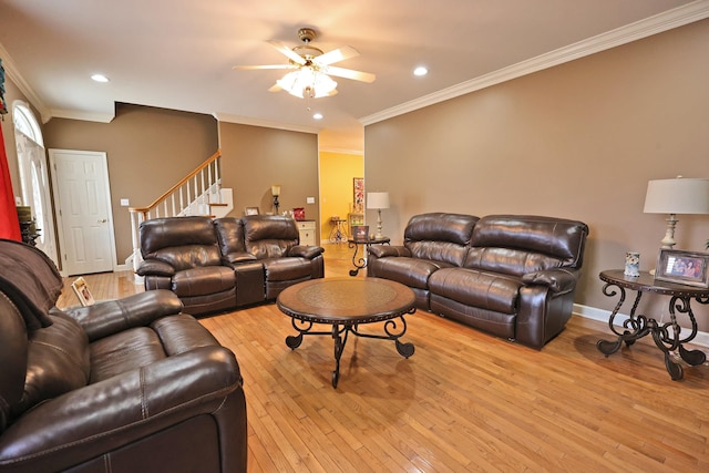 living room with ceiling fan, light wood-type flooring, and crown molding