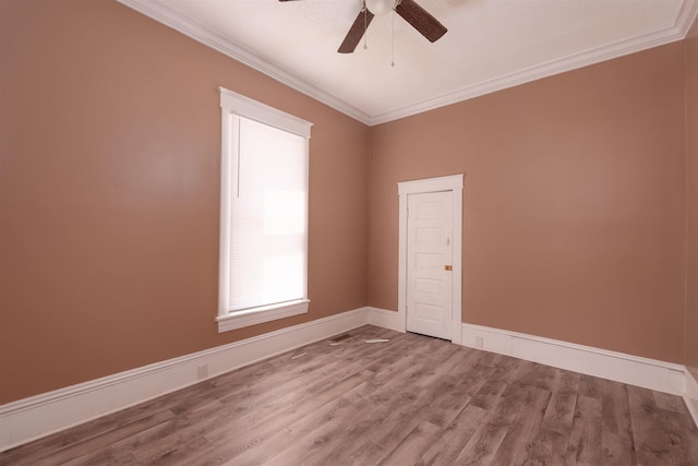 empty room featuring a ceiling fan, baseboards, ornamental molding, and wood finished floors