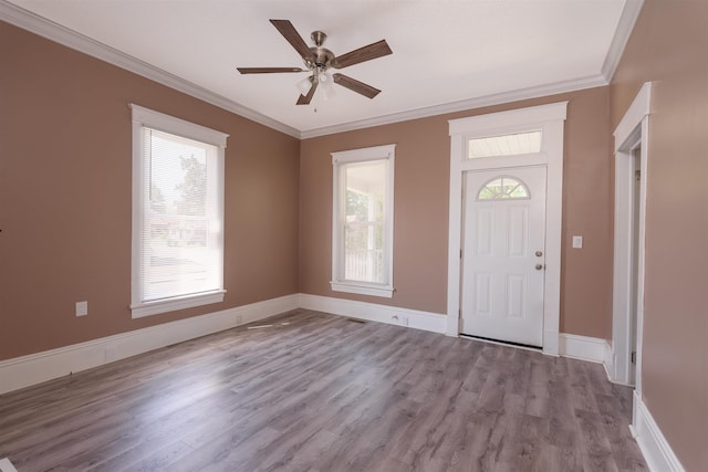 foyer entrance featuring baseboards, ornamental molding, a ceiling fan, and wood finished floors