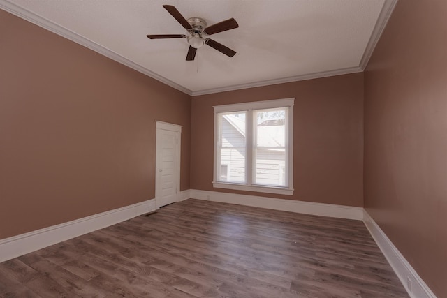 unfurnished room featuring crown molding, baseboards, a ceiling fan, and dark wood finished floors
