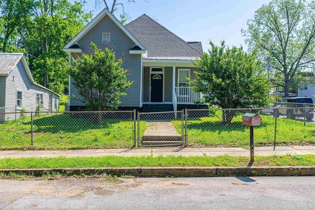 view of front of house featuring a shingled roof, a gate, covered porch, and a fenced front yard