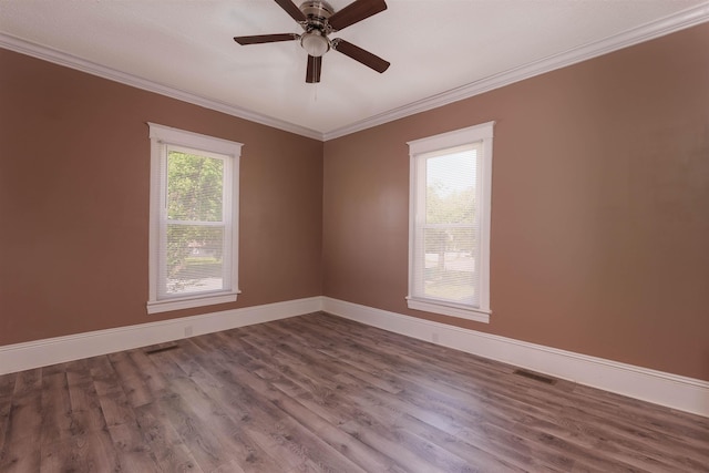 unfurnished room with visible vents, crown molding, baseboards, ceiling fan, and dark wood-style floors