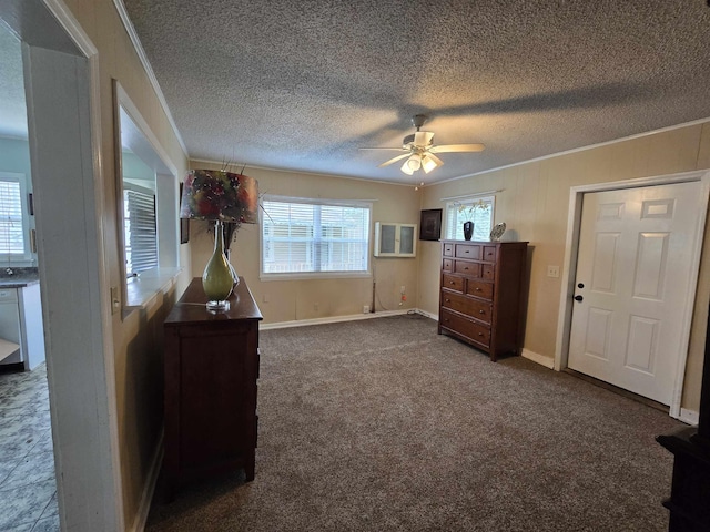  - bedroom featuring crown molding, a textured ceiling, dark carpet, and ceiling fan