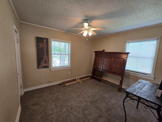 - bedroom with ornamental molding, a textured ceiling, dark carpet, and ceiling fan