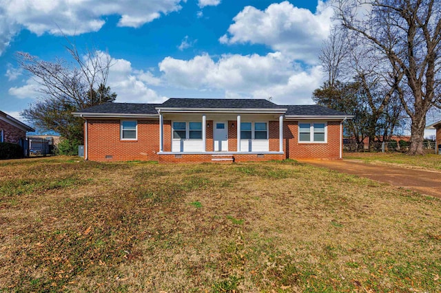 ranch-style home featuring covered porch and a front yard