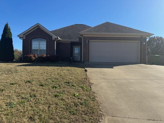 ranch-style house with a garage, driveway, brick siding, and a front yard