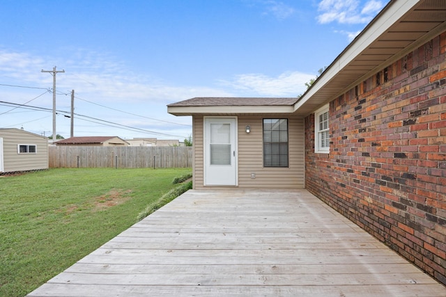 wooden deck featuring a lawn