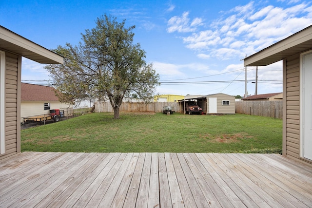 wooden terrace featuring a lawn and a shed