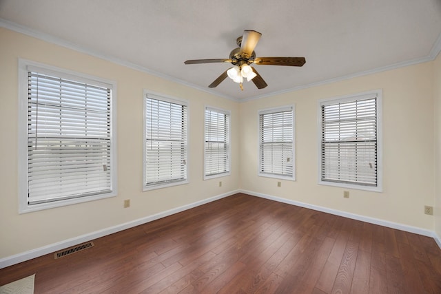 empty room featuring dark hardwood / wood-style floors, ceiling fan, and crown molding