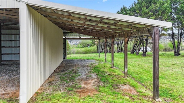 view of vehicle parking with driveway and a carport