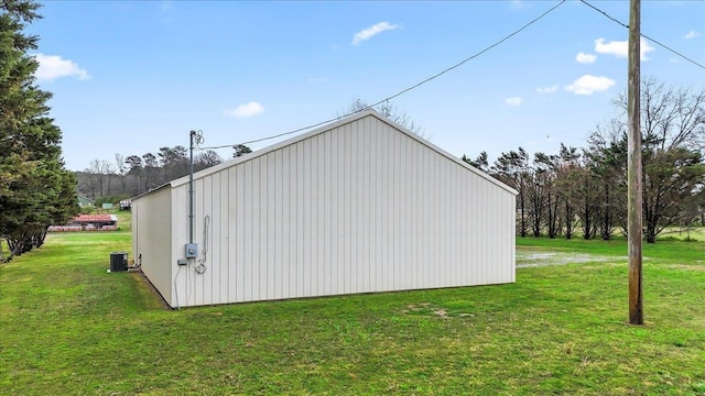 view of pole building featuring a lawn and central AC