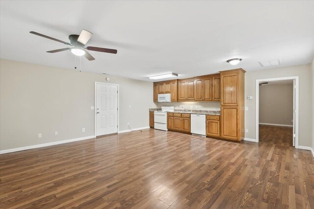 kitchen with light countertops, white appliances, dark wood-type flooring, visible vents, and a ceiling fan