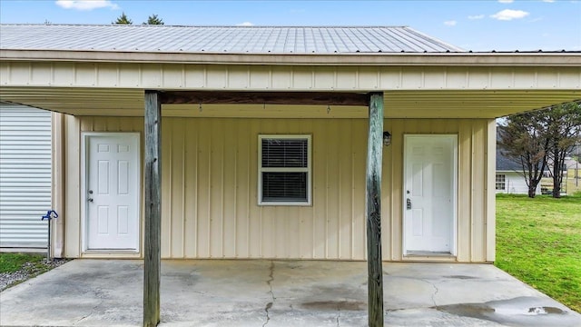 view of exterior entry featuring a yard