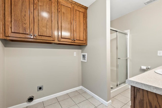 washroom with light tile patterned flooring, hookup for an electric dryer, baseboards, visible vents, and hookup for a washing machine
