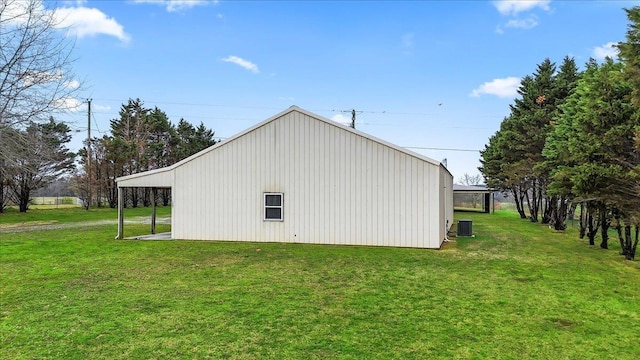 view of pole building with central AC unit and a lawn
