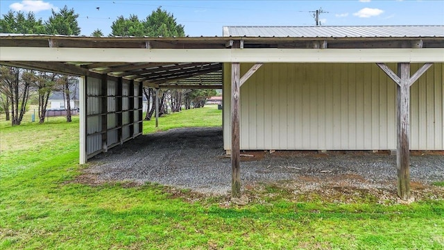 view of vehicle parking with an outbuilding and a carport