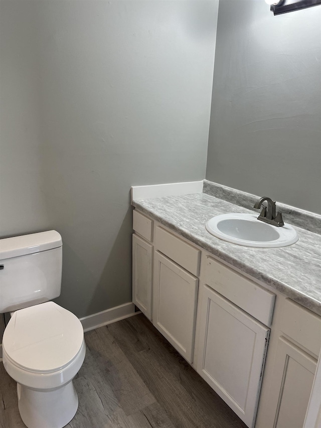  - bathroom with vanity, wood-type flooring, and toilet