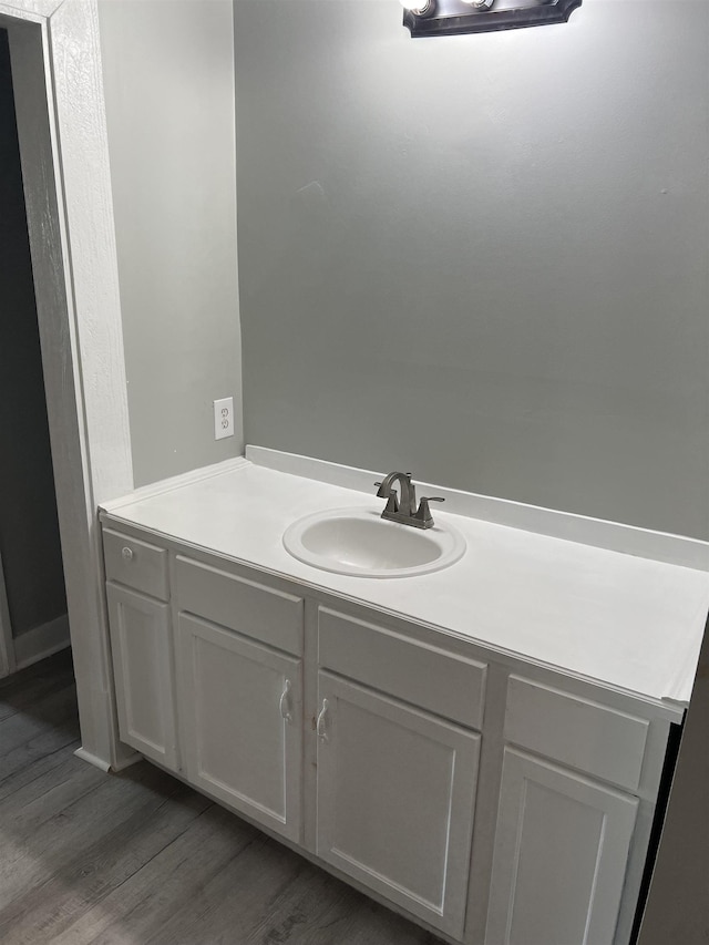  - bathroom featuring hardwood / wood-style floors and vanity