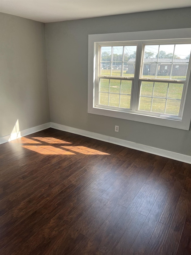  - unfurnished room with dark wood-type flooring