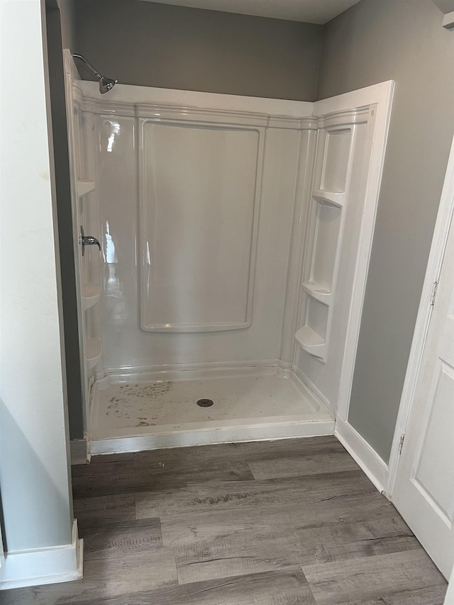  - bathroom featuring hardwood / wood-style flooring and walk in shower
