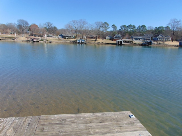 view of dock featuring a water view and a residential view