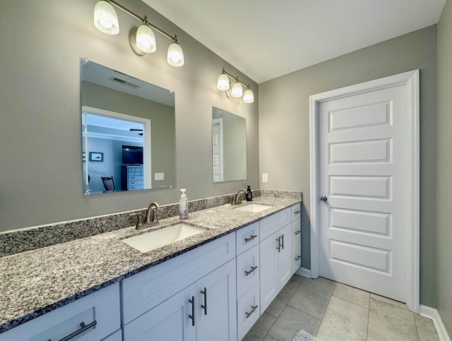 bathroom with double vanity, tile patterned flooring, visible vents, and a sink