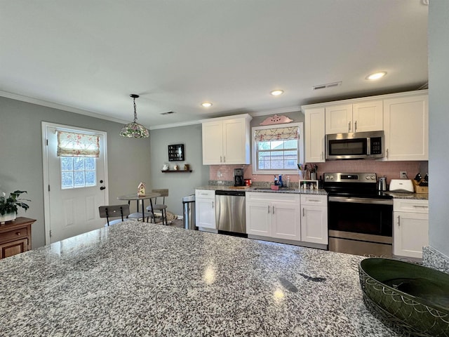 kitchen featuring visible vents, white cabinetry, and stainless steel appliances