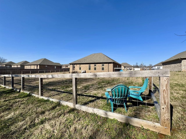 view of yard featuring a residential view and fence