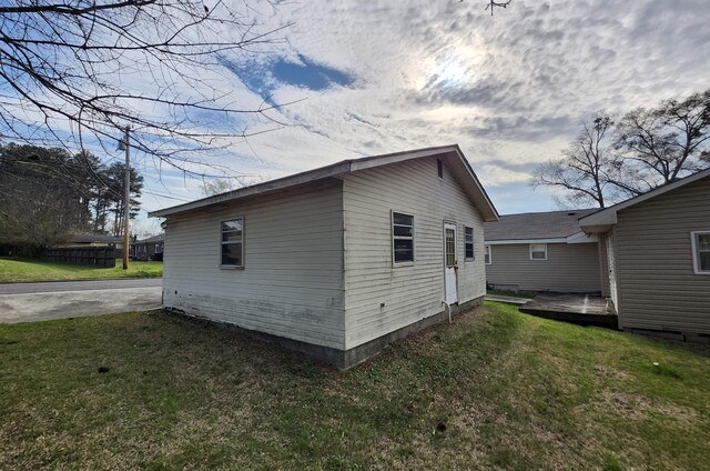  - view of home's exterior featuring a yard