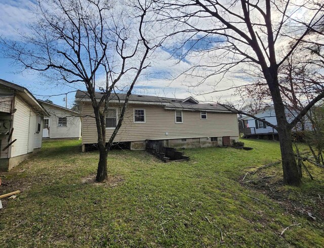  - rear view of property featuring a yard