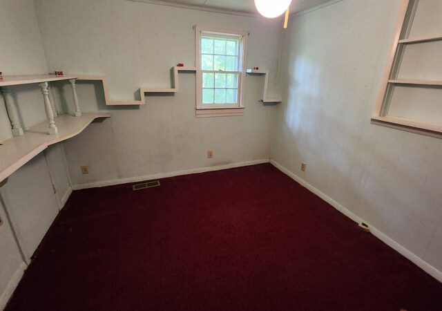  - spare room featuring dark carpet and baseboards