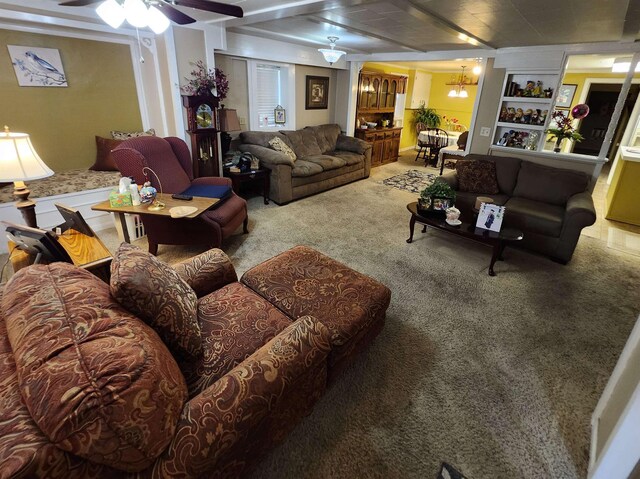  - living area featuring a chandelier, crown molding, and carpet