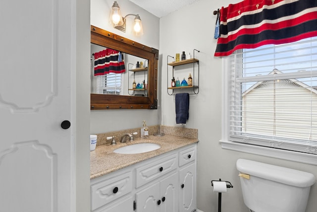 bathroom featuring toilet and vanity