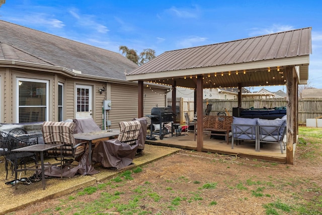 view of patio / terrace featuring a gazebo, area for grilling, and fence