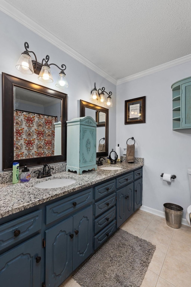 bathroom with vanity, ornamental molding, a textured ceiling, and tile patterned floors