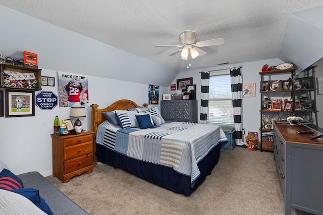 bedroom with light carpet, ceiling fan, a textured ceiling, and lofted ceiling