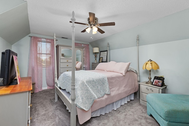 bedroom with light colored carpet, vaulted ceiling, a textured ceiling, and ceiling fan