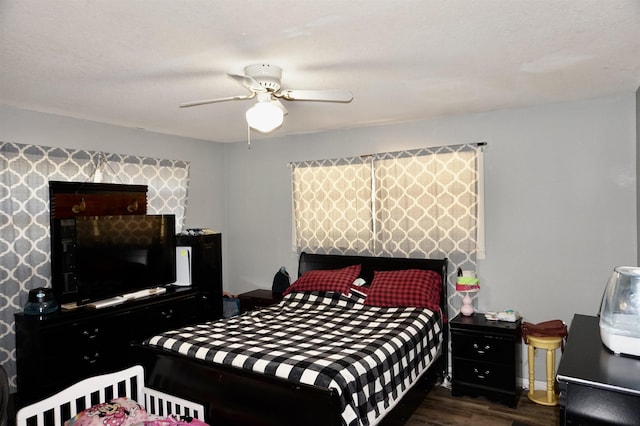 bedroom featuring ceiling fan and dark wood-type flooring