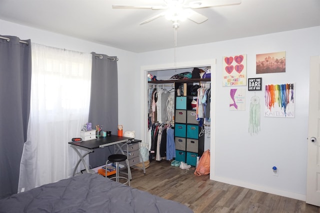 bedroom with ceiling fan, a closet, and wood-type flooring