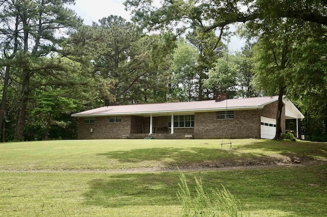 back of property featuring a yard and a garage