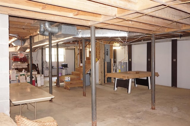 basement featuring electric panel and water heater