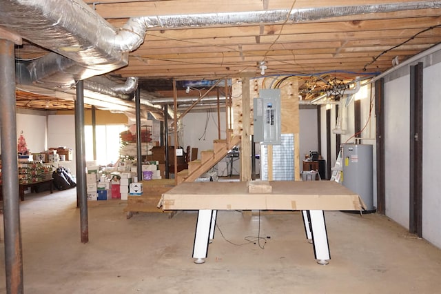 basement featuring electric panel and water heater