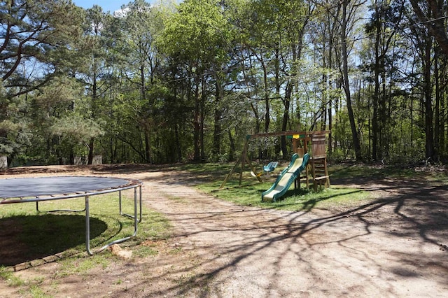 view of yard featuring a playground and a trampoline