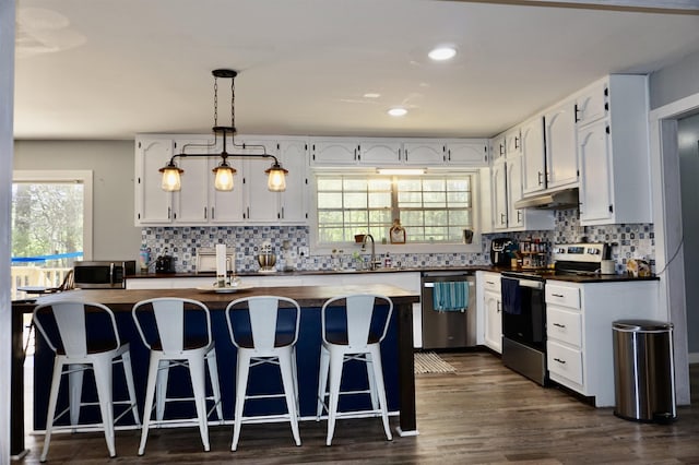 kitchen featuring white cabinets, appliances with stainless steel finishes, and a center island