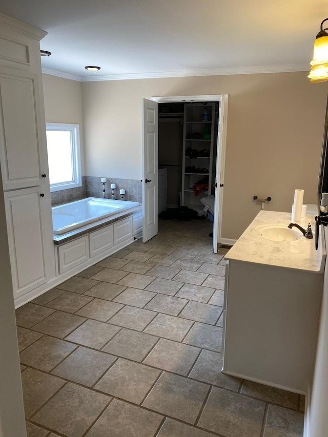 bathroom with a washtub, crown molding, and vanity